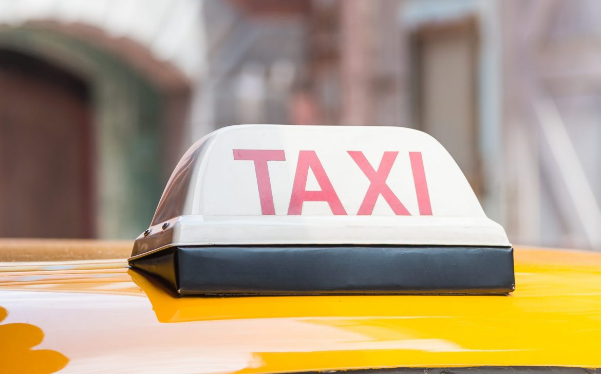 Taxi sign on roof top car